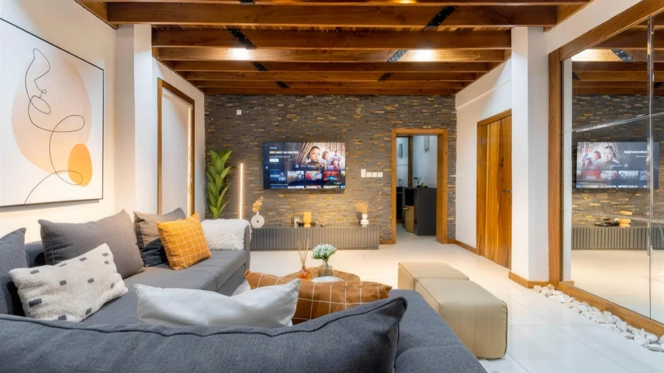 Living room with stone feature wall and grey sofa