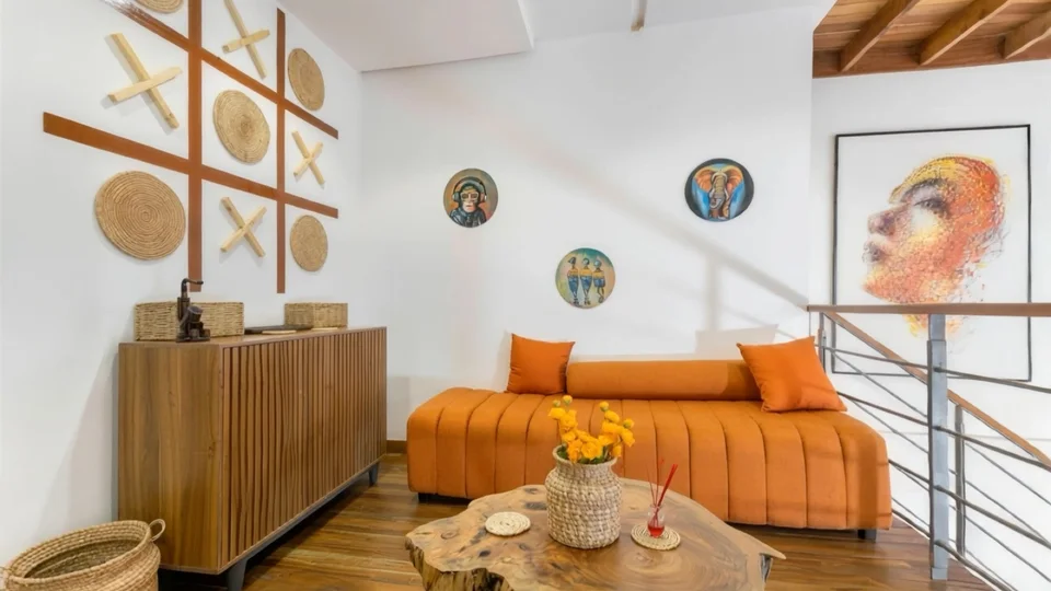 Mezzanine seating with orange sofa and artwork